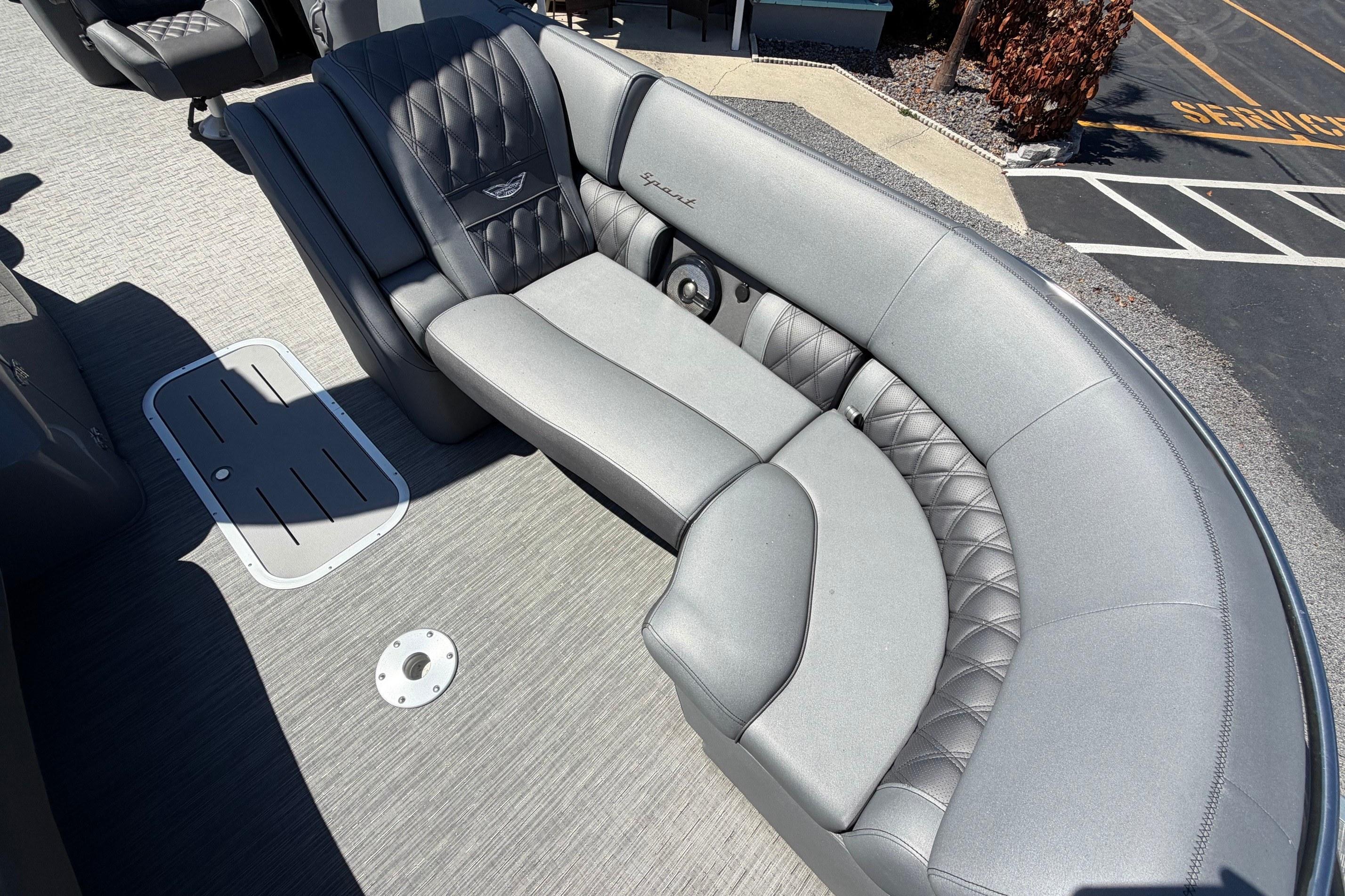 Luxurious seating on a 2022 Bennington 25 QX pontoon boat, featuring quilted upholstery.