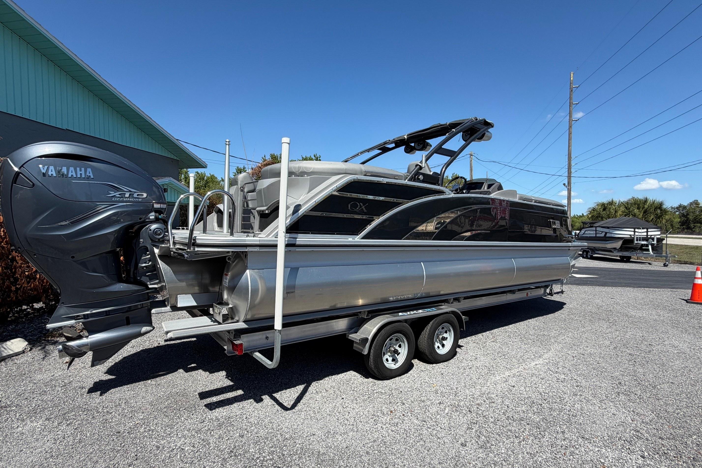 2022 Bennington 25 QX pontoon boat with Yamaha XTO outboard engine on trailer.