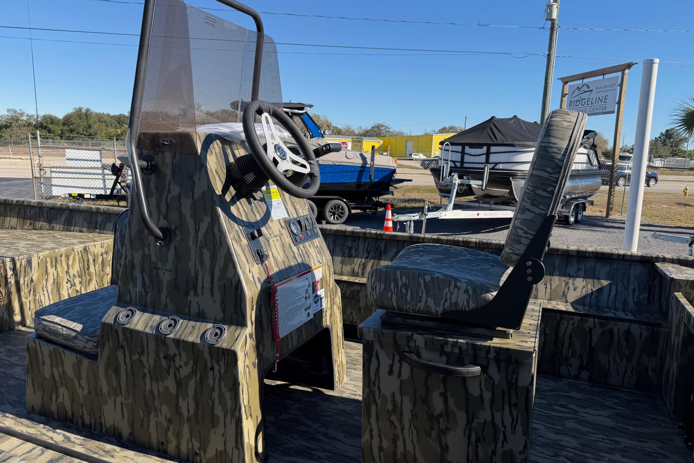 2026 Smoker Craft Sportsman 1866 boat interior with camouflage design and steering console.