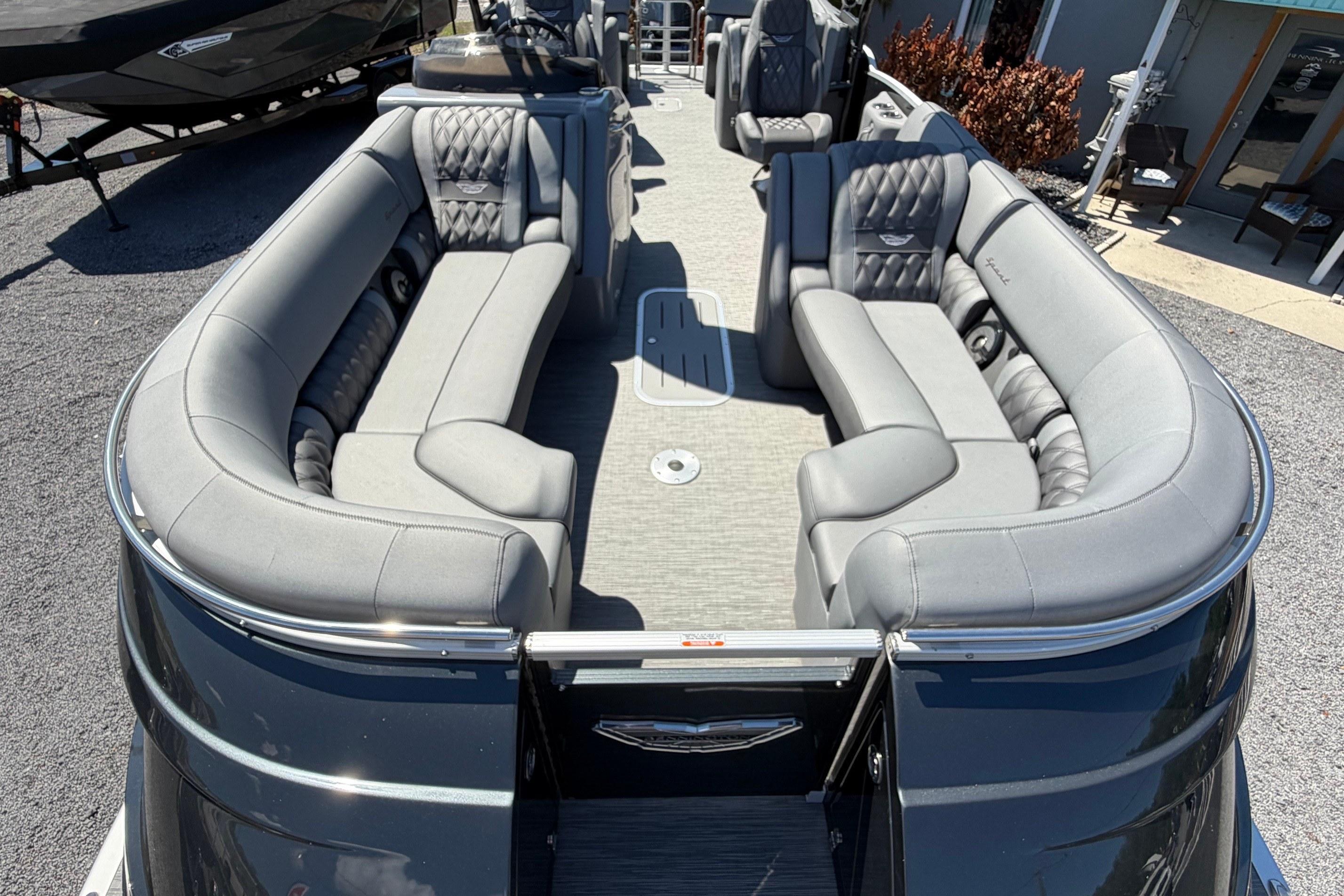 2022 Bennington 25 QX pontoon boat with luxurious gray seating and spacious deck.