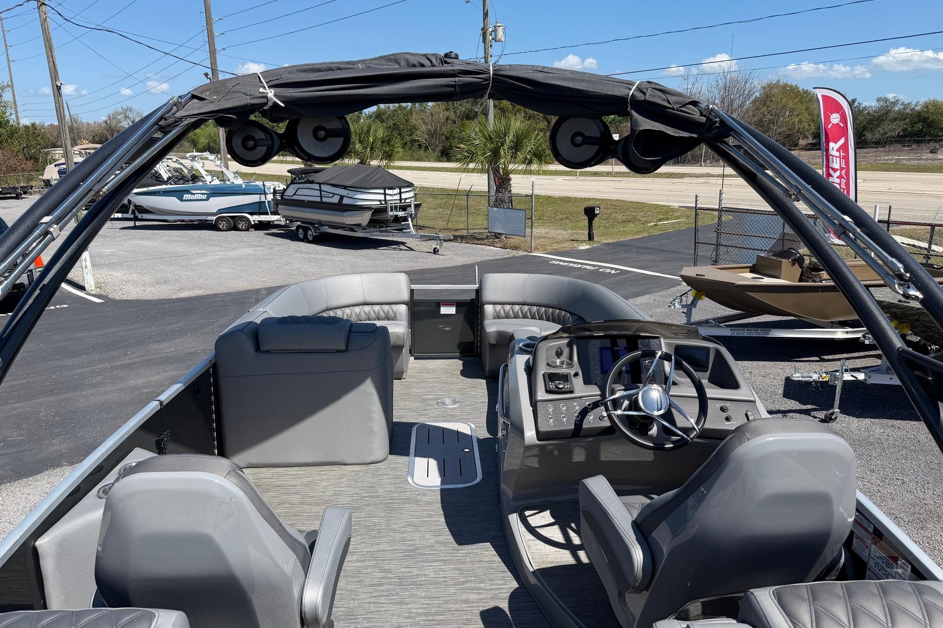2022 Bennington 25 QX pontoon boat interior with helm, seating, and canopy.