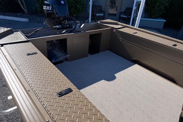 2026 Smoker Craft Pro Sportsman 1660 boat interior with Suzuki engine, featuring spacious deck.