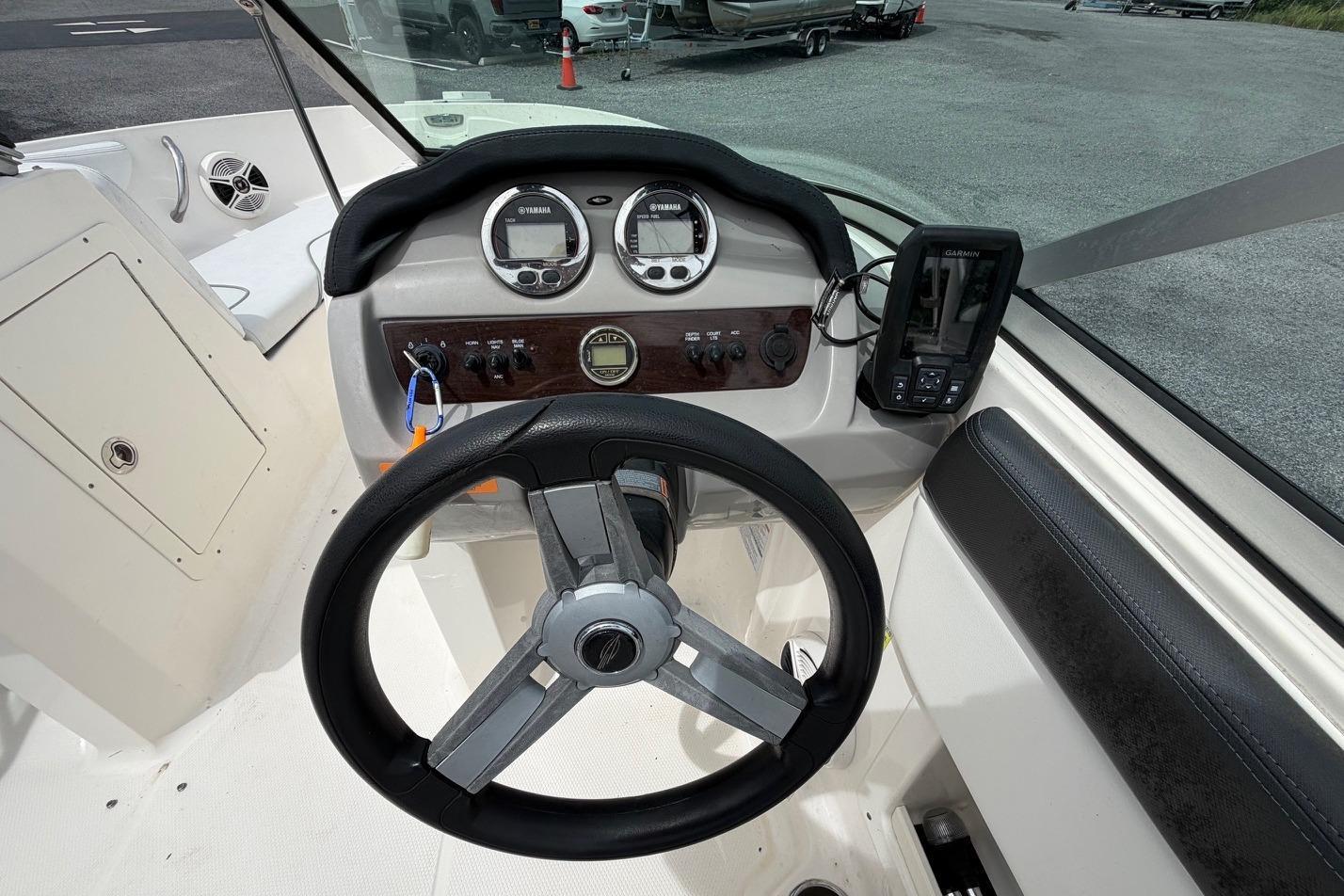 2020 Chaparral 196 SSi boat dashboard with steering wheel and navigation instruments.