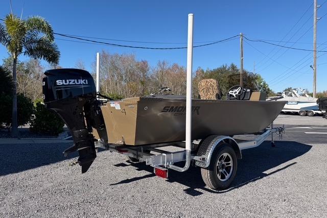 2026 Smoker Craft Pro Sportsman 1660 boat on trailer with Suzuki outboard motor.