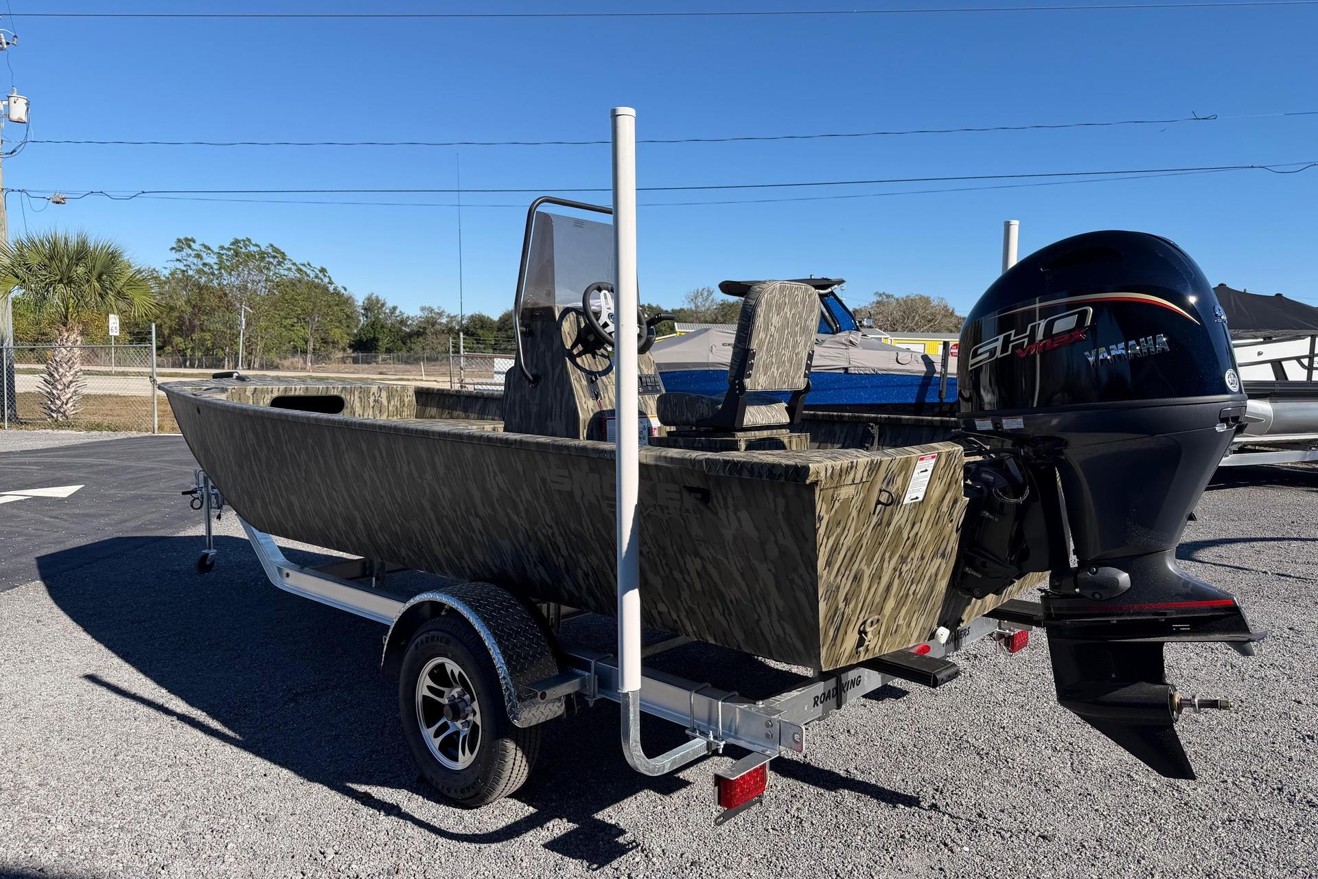 2026 Smoker Craft Sportsman 1866 boat with Yamaha engine on trailer, outdoors.