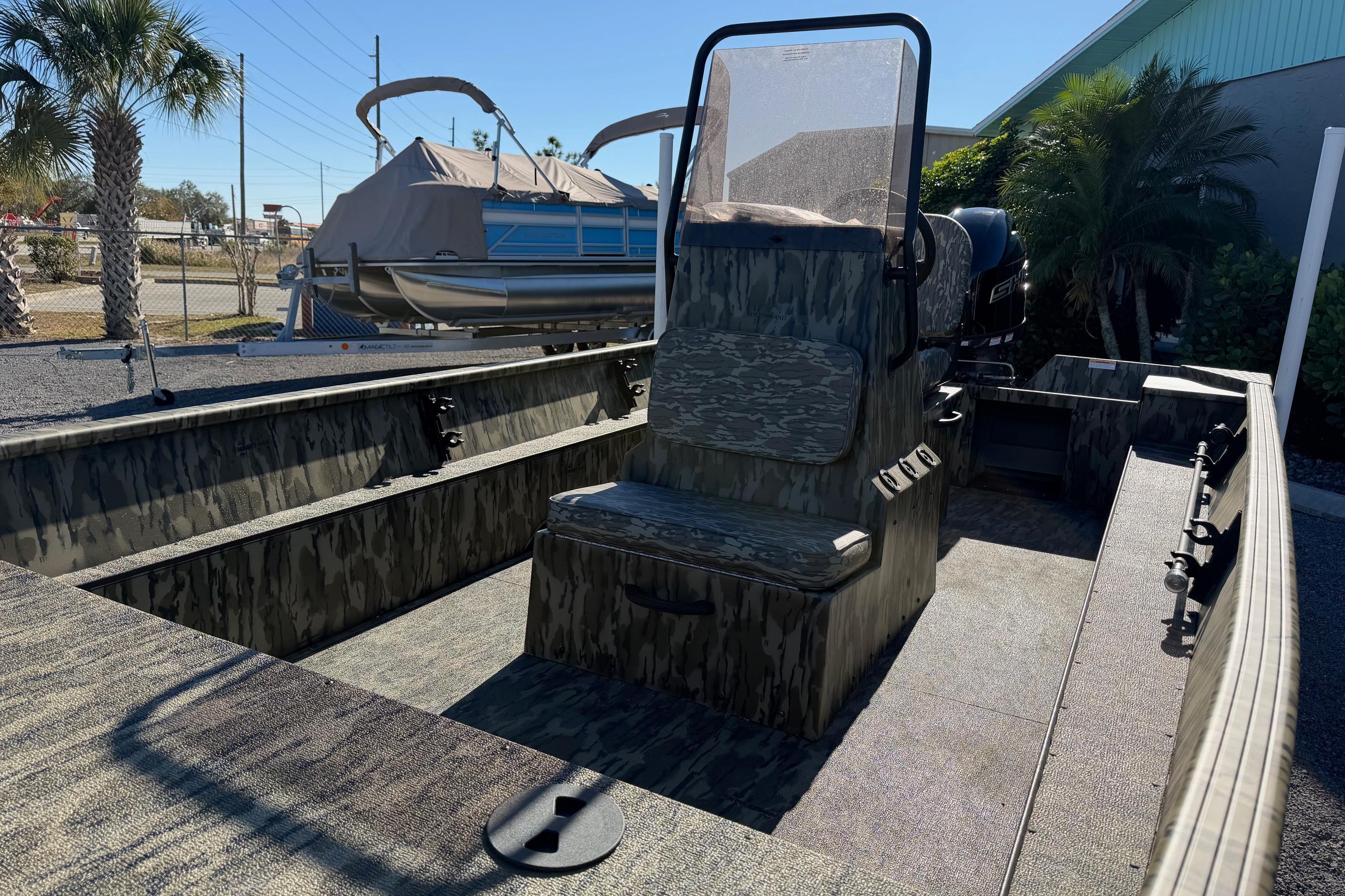 2026 Smoker Craft Sportsman 1866 boat with camouflage interior, parked outdoors.