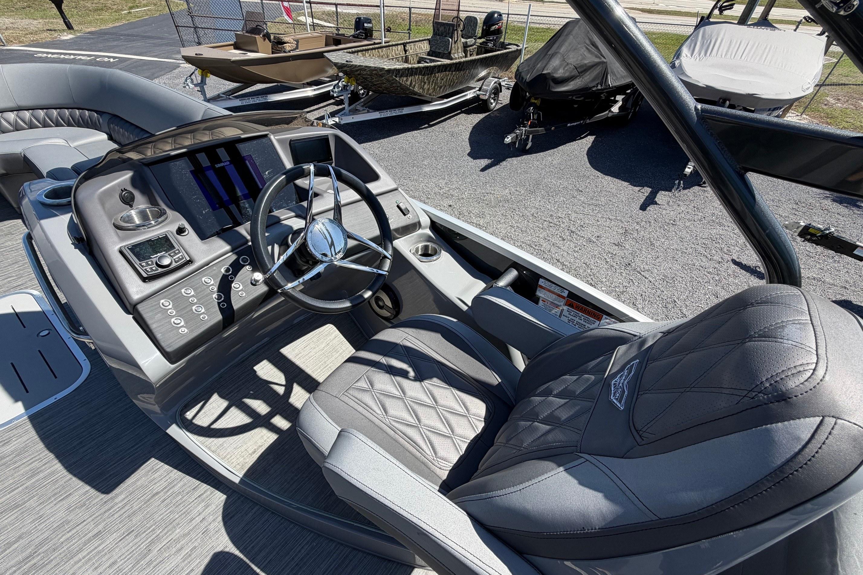 2022 Bennington 25 QX boat interior with steering wheel and control panel.