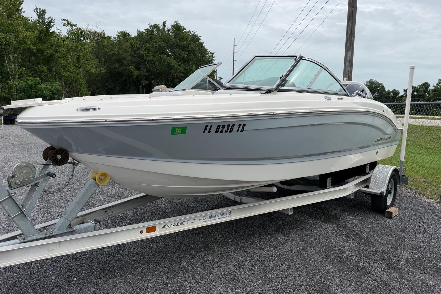 2020 Chaparral 196 SSi boat on trailer, parked outdoors, showcasing sleek design.