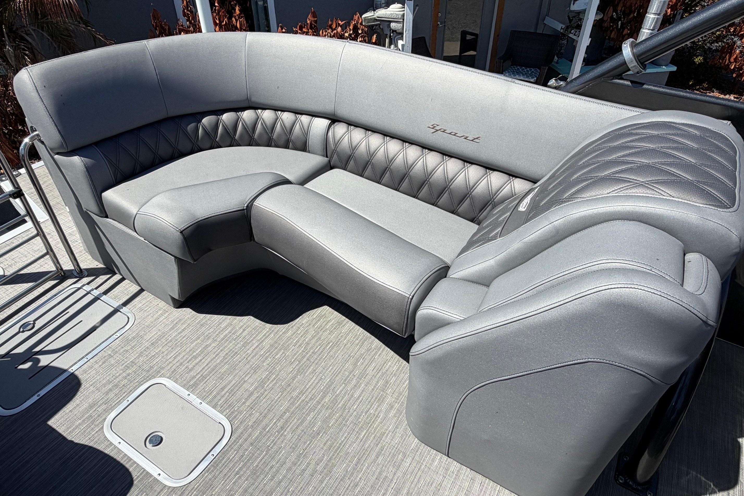 Luxurious seating on a 2022 Bennington 25 QX boat, featuring elegant gray upholstery.