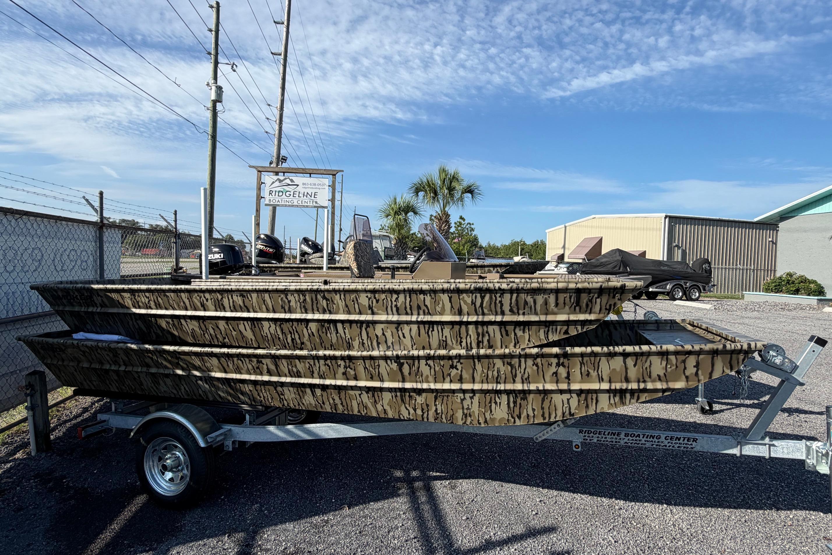 2026 Smoker Craft 1432 Jon boat with camouflage design on a trailer at Ridgeline Boating Center.